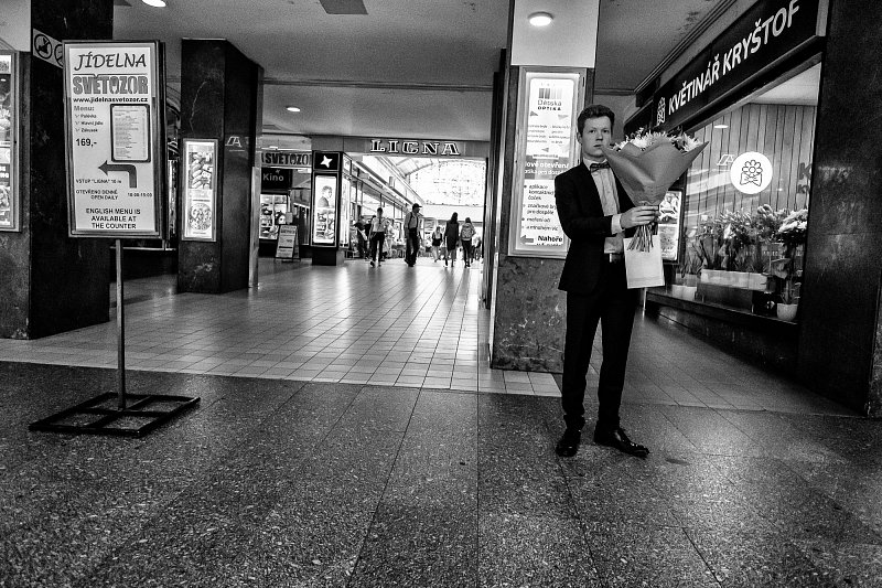 A man reading in a city passage